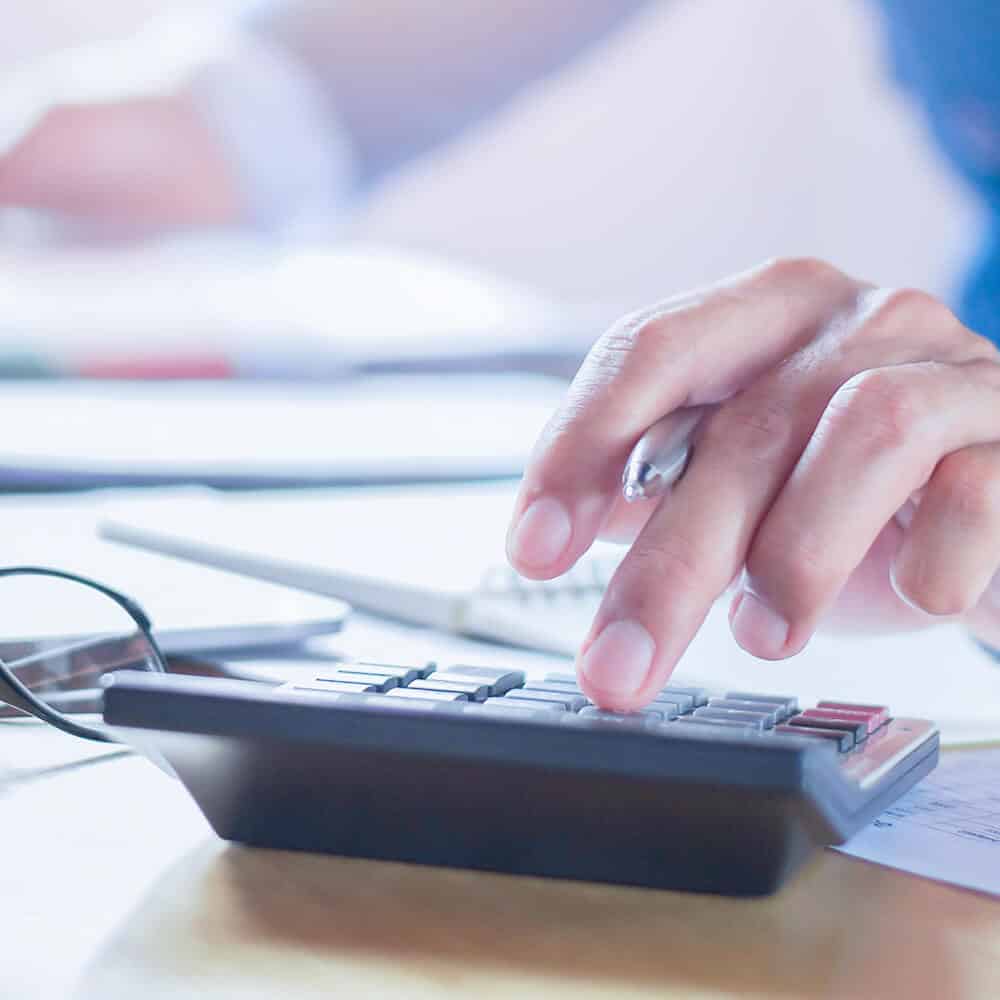 Hearing Services | Image of a hand using a calculator