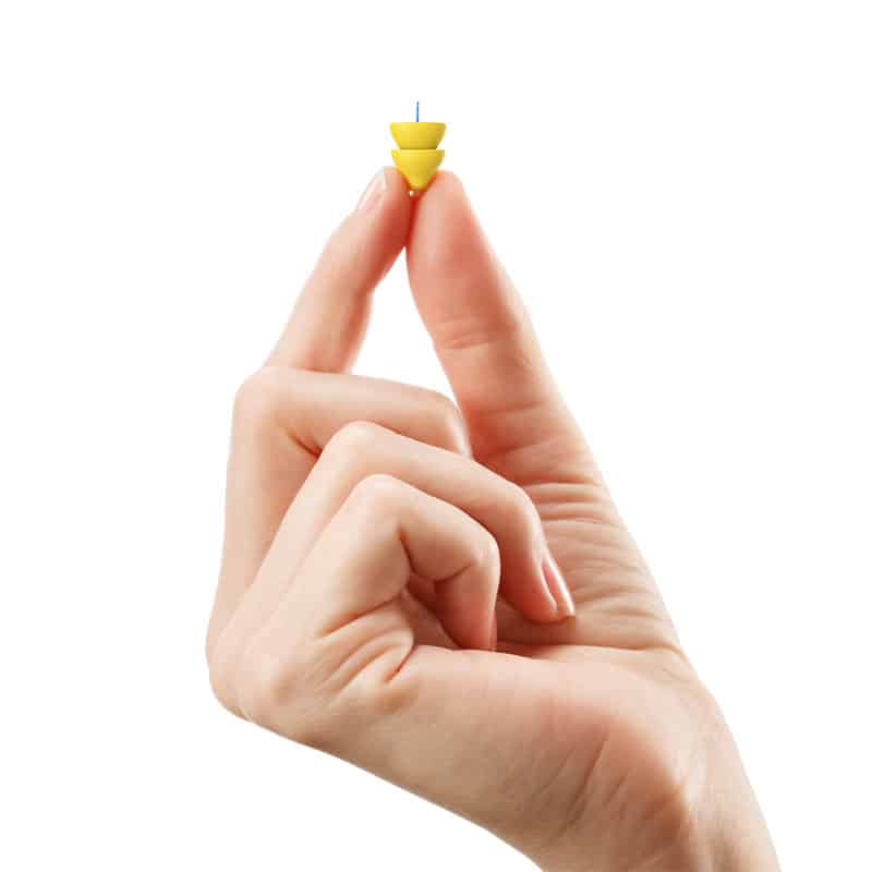Tinnitus Treatment | A hand holding up an ear plug